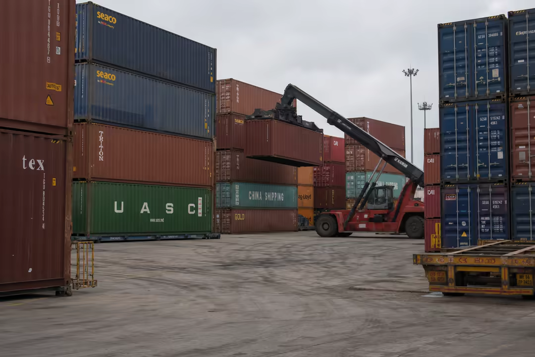 Stacked containers and a reach stacker at work in an inland container yard