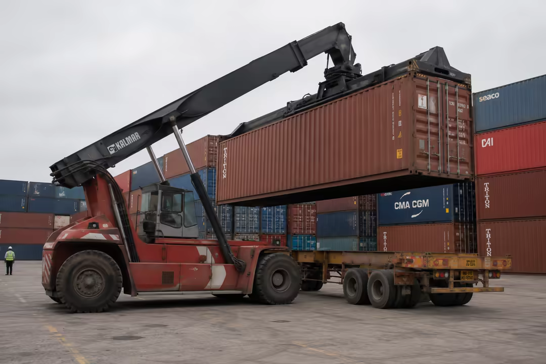 A reach stacker placing a container onto a trailer at the terminal