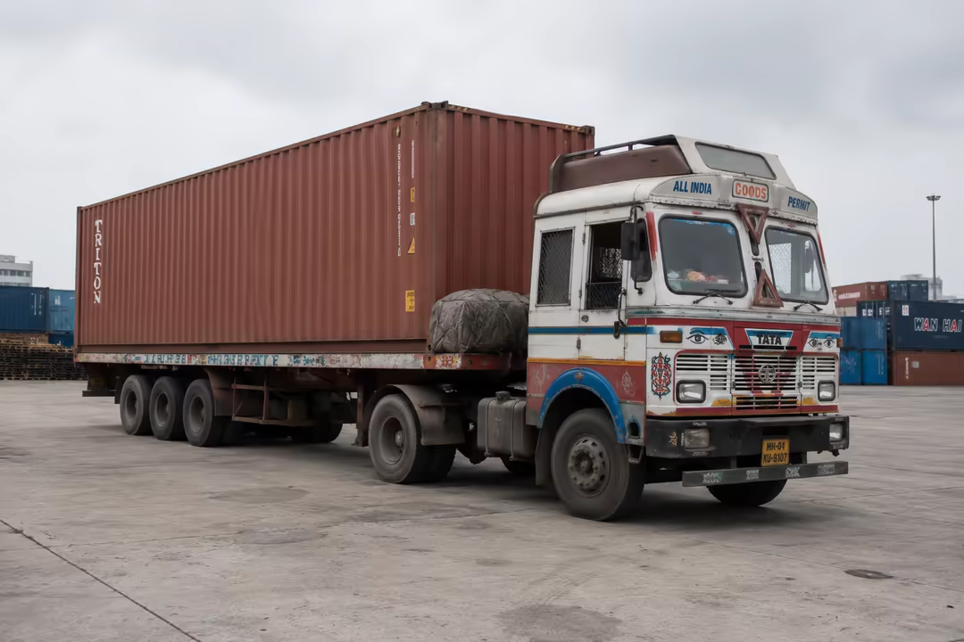 Container trailer coupled to a truck in the yard, ready to move